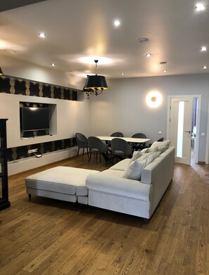 Deluxe Apartment, 3 Bedrooms | Living area | 139-cm LED TV with digital channels, TV, heated floors