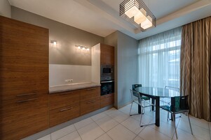 Deluxe Apartment, 3 Bedrooms | Private kitchen | Full-sized fridge, microwave, oven, stovetop
