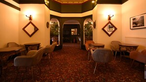 A hotel lobby with a red carpet, ornate ceiling, and classic furniture. - Pinegrove Hotel (Carlisle)