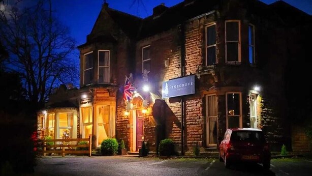 A two-story building with a sign reading 'Pinegrove Hotel.' - Pinegrove Hotel (Carlisle)