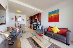 Basic Apartment | Living area | 32-inch plasma TV with satellite channels, TV - Portico Beachfront Condo (Cape Town)