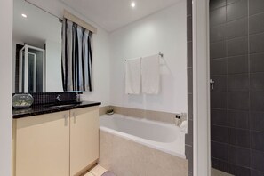 Basic Apartment | Bathroom | Deep soaking tub, designer toiletries, hair dryer, towels