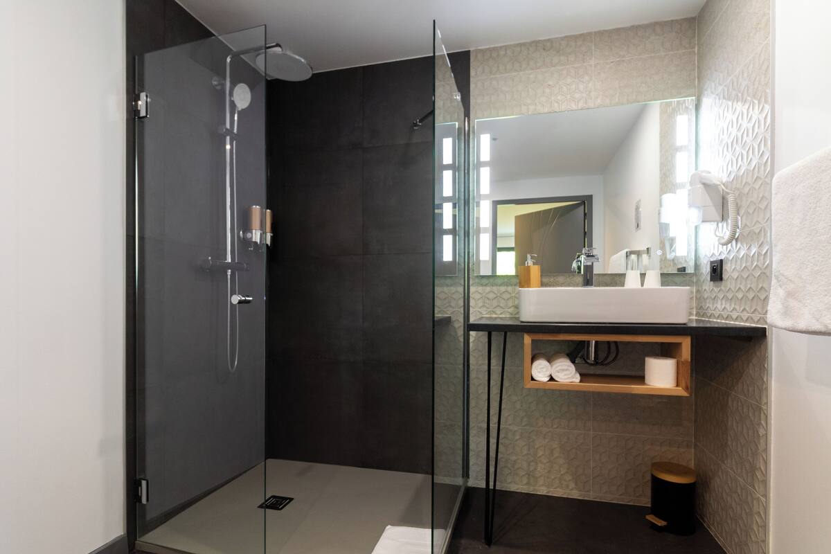 standard double room | bathroom | shower, hair dryer, towels, soap