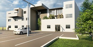 Stylish building with a flat roof, large windows, and neutral-toned exterior.
