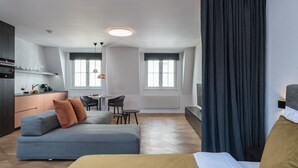 A modern hotel room with a sofa, bed, dining area, and kitchen. - Exclusive home in heart of Prague (Prague)