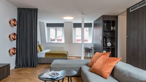 A modern living room with a grey sofa, a small coffee table, and a bookshelf. - Exclusive home in heart of Prague (Prague)