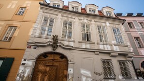 A historic building with ornate architecture, a large wooden door, and multiple windows. - Exclusive home in heart of Prague (Prague)