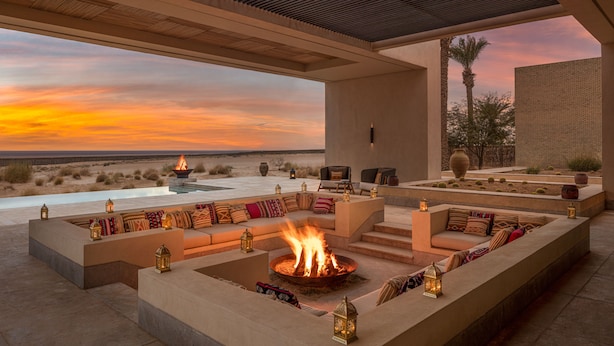 An outdoor seating area with a fire pit, cushioned seating, and lanterns. - The Mora Sahara Tozeur (Tozeur)