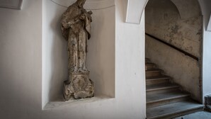 A stone statue in a niche with a staircase in the background. - Hidden gem in heart of Prague (Prague)