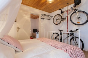 Relax in this inviting space with a comfortable bed, bicycle storage, and a convenient door to the next area.