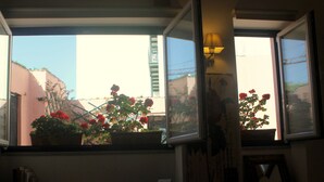 A window with potted plants and a lamp.