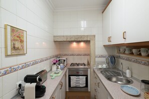 Enjoy cooking in this well-equipped kitchen with oven, microwave, and compact dishwasher.