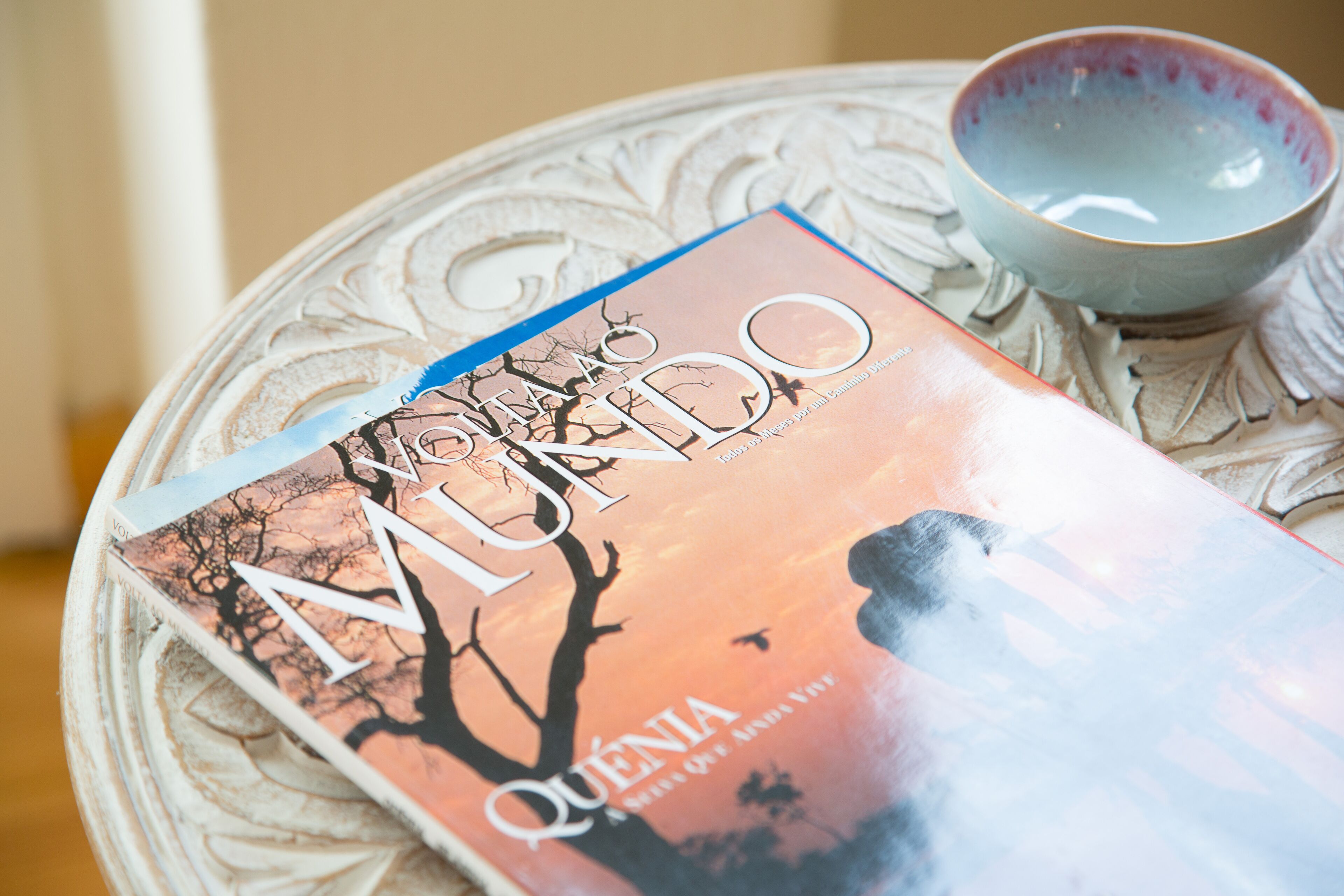 Um livro intitulado 'Quien' sobre uma mesa com uma tigela decorativa.