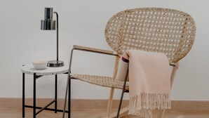 A modern room with a rocking chair, a small table with a lamp, and wall art. - Bright & Spacious W/ Orange Tree Patio Apartment by TimeCooler (Lisbon)