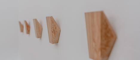 A series of wooden blocks of varying sizes arranged in a line on a white background.
