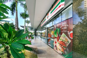 A 7-Eleven store with a large outdoor advertisement. - Rivergate Residence Apartments (Ho Chi Minh City)