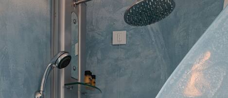 A modern shower with a handheld showerhead and a fixed wall-mounted showerhead.