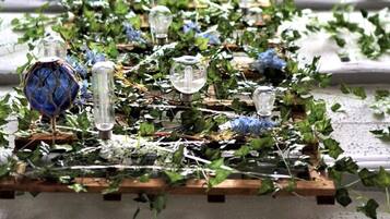 A table covered with ivy and decorative glass objects.