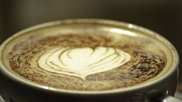 A close-up of a cup of coffee with a latte art design.
