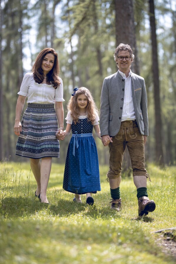 A family walking in a forested area.