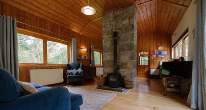 Secluded woodland cottage on the banks of a pristine Highland river