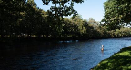 Secluded woodland cottage on the banks of a pristine Highland river