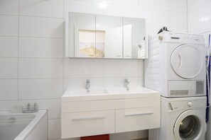 Bathtub, hair dryer, towels, soap