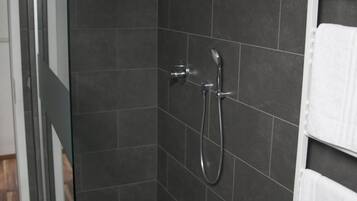 Shower, rainfall showerhead, slippers, towels