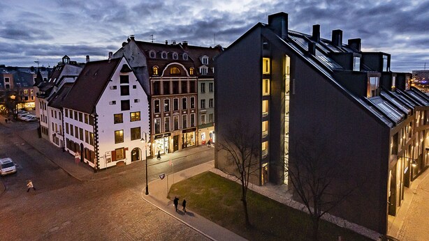 A historic building with a traditional European architectural style, featuring a steeply pitched roof and a symmetrical facade with multiple windows. - WINWINSTAY Residence in Heart of Old Town (Riga)