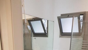 A bathroom with a white sink, a toilet, and a glass shower enclosure. - Gorgeous Studio On Hilton Beach (Tel Aviv)