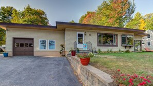 A two-story house with a garage, a front porch, and a well-maintained lawn. - SUPERB VIEW BIG  SEBAGO LAKE WESTERN SIDE OF LAKE (Standish)