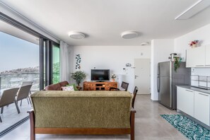 Luxury Apartment | Living area | 50-inch flat-screen TV with cable channels, TV, Netflix