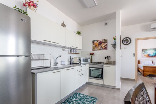 Luxury Apartment | Private kitchen | Full-sized fridge, oven, stovetop, espresso maker