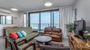 Luxury Apartment | Living area | 50-inch flat-screen TV with cable channels, TV, Netflix