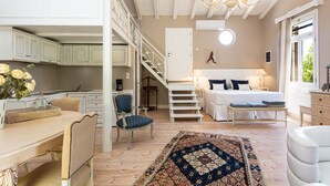 A bedroom with a bed, bedside table, and a window. There is a staircase leading to an upper level. -  A Grand Estate, with 2 Pools, Gym & Tennis Court (Peza)