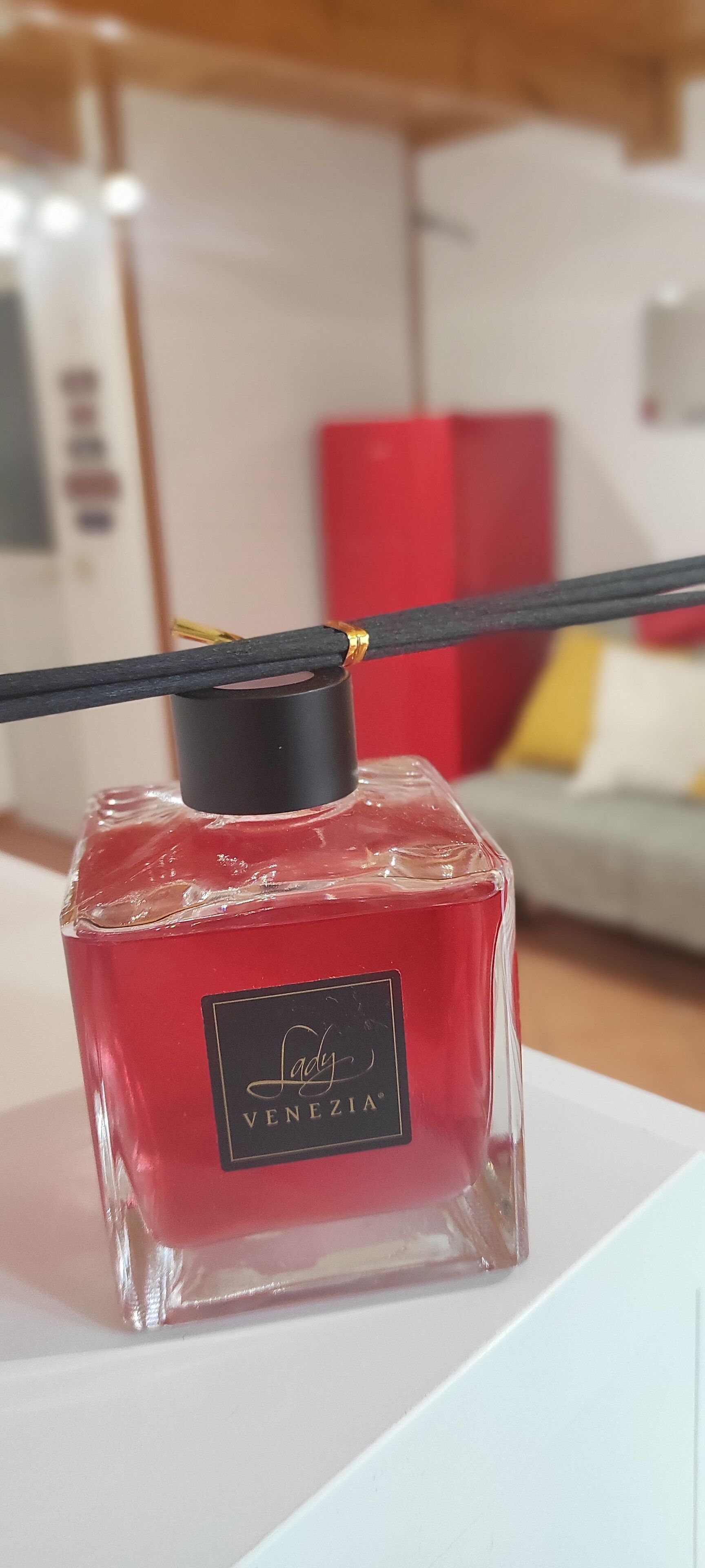 Une bouteille de parfum Lady Gaga Venezia sur une surface blanche.