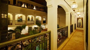 A multi-level hotel interior with arched corridors, ornate railings, and traditional decor. - Riad Sokera Hotel & Spa - Adults Only (Marrakech)