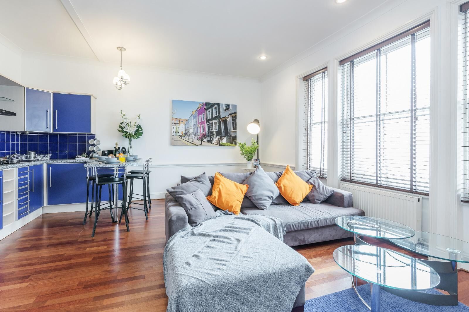 A modern apartment with a kitchen, dining area, and living room.