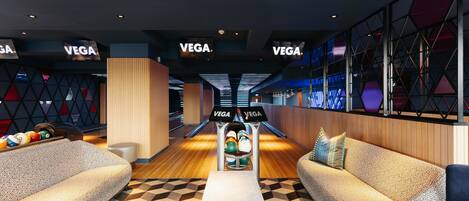A bowling alley with multiple lanes, seating areas, and a modern design.