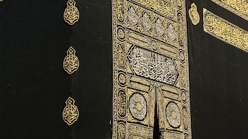 A close-up of a black and gold ornate structure with intricate calligraphy.