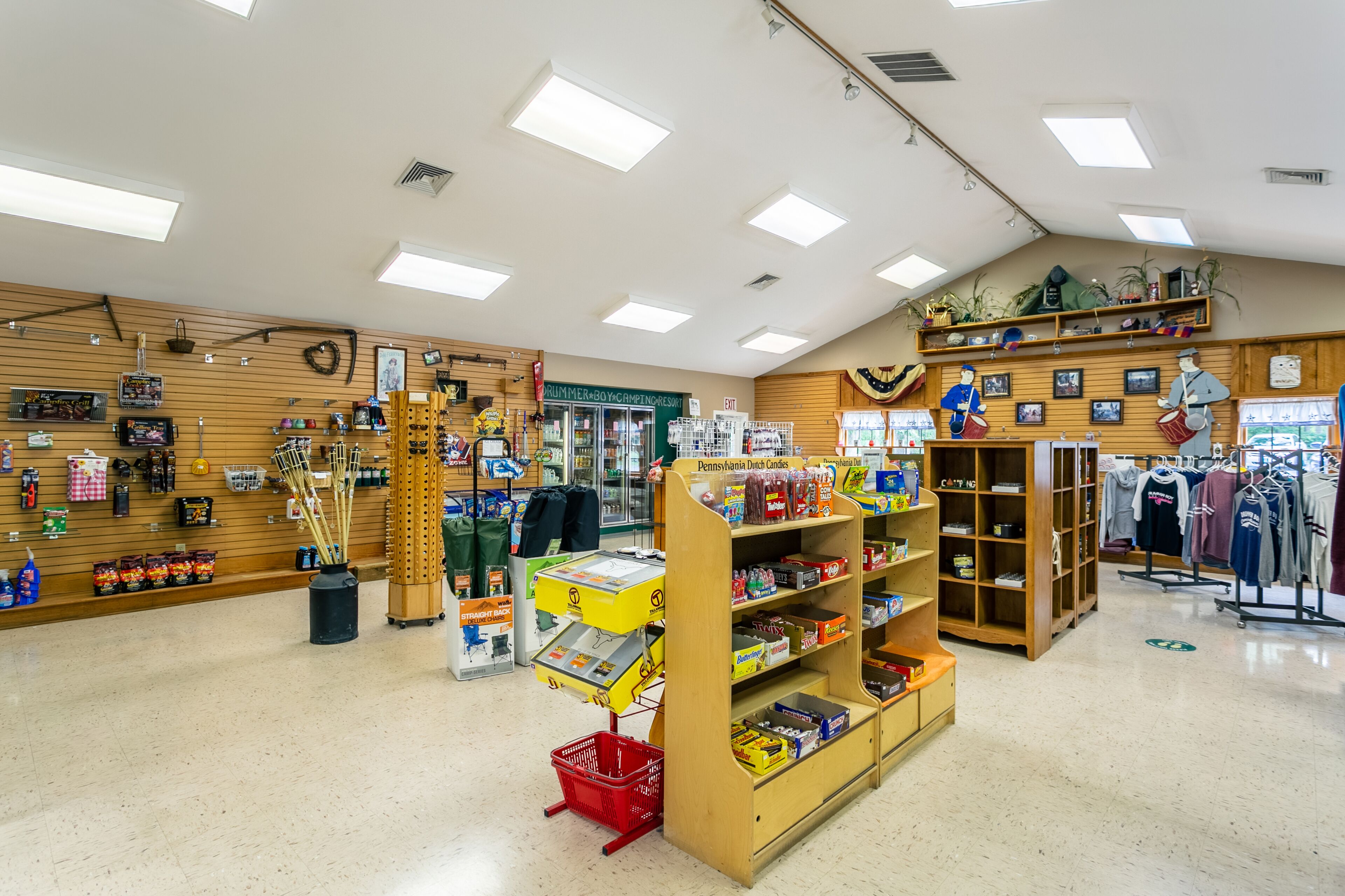 A store interior with wooden shelves, a cash register, and various items on display.