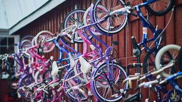 Bicycles parked against a wooden wall.