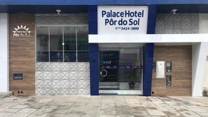 L’extérieur de l’hôtel Palace présente un design moderne, avec une entrée imposante et un numéro de téléphone clairement affiché.