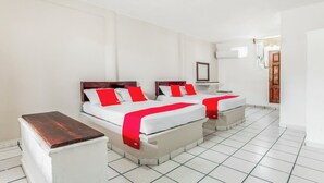 A hotel room with two beds, white walls, and a tiled floor. - OYO Hotel Jaguar (Cancun)