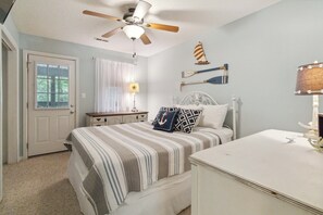 A bedroom with a bed, a desk, a ceiling fan, and a window with curtains. - Welcome to “Relax Inn” Retreat at Lake Cumberland – A Perfect Cabin Escape (Burnside)
