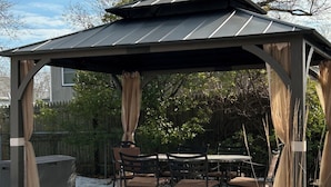 A gazebo with a table and chairs, surrounded by snow and trees. - Pet friendly cottage by the Delaware Bay-Townbank  (Townbank)