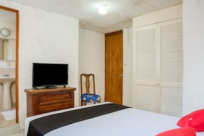 Enjoy a restful stay in this cozy room with a neatly made bed, flat-screen TV, and convenient sink.