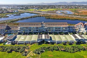 A large hotel with multiple floors and a central courtyard. - Dolphin Beach H106 (Cape Town)