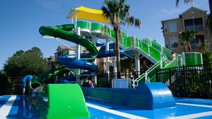A water park with multiple slides and a pool area. - Disney at Your Doorstep by VillaDirect (Kissimmee)