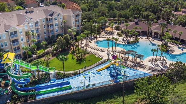 A resort with multiple swimming pools, a water park, and a large building with balconies. - Disney at Your Doorstep by VillaDirect (Kissimmee)